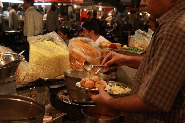Street-food stalls lit up at Manek Chowk at night