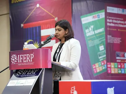 A speaker addressing the audience from the IFERP podium