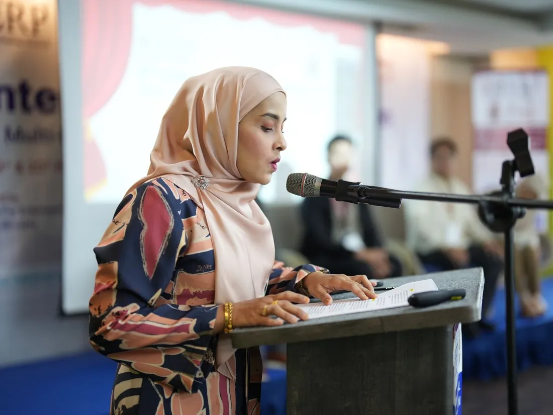 A delegate delivering an oral presentation at the podium during an IFERP international conference